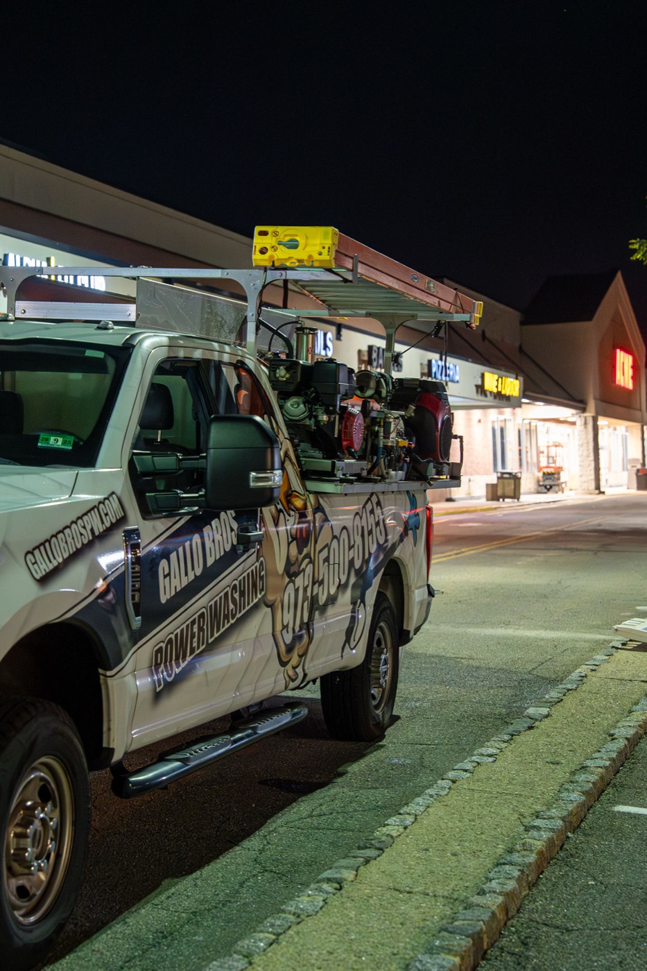 Gallo Bros wrapped truck on a commercial job at night